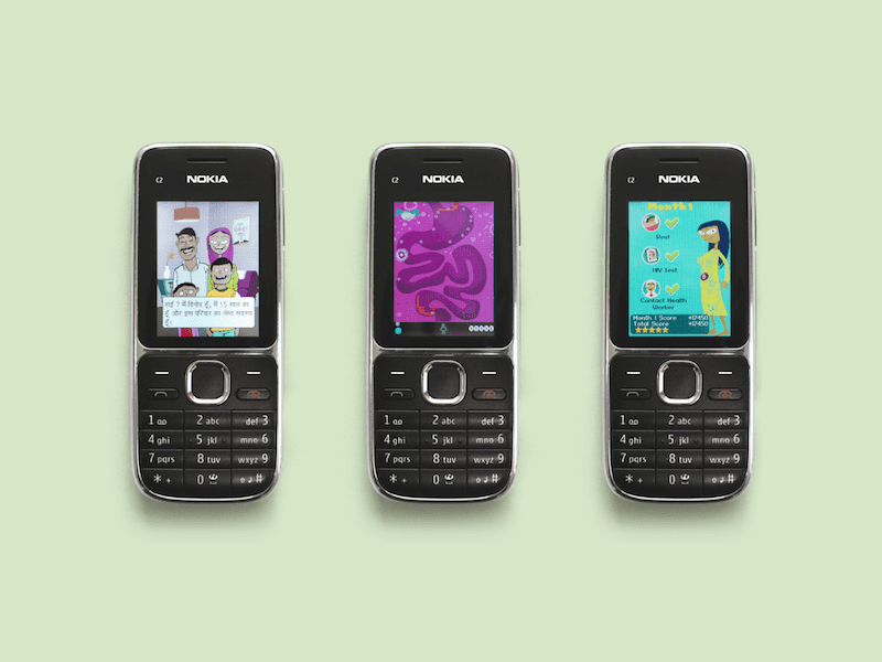 3 feature phones each displaying a different game on their screen